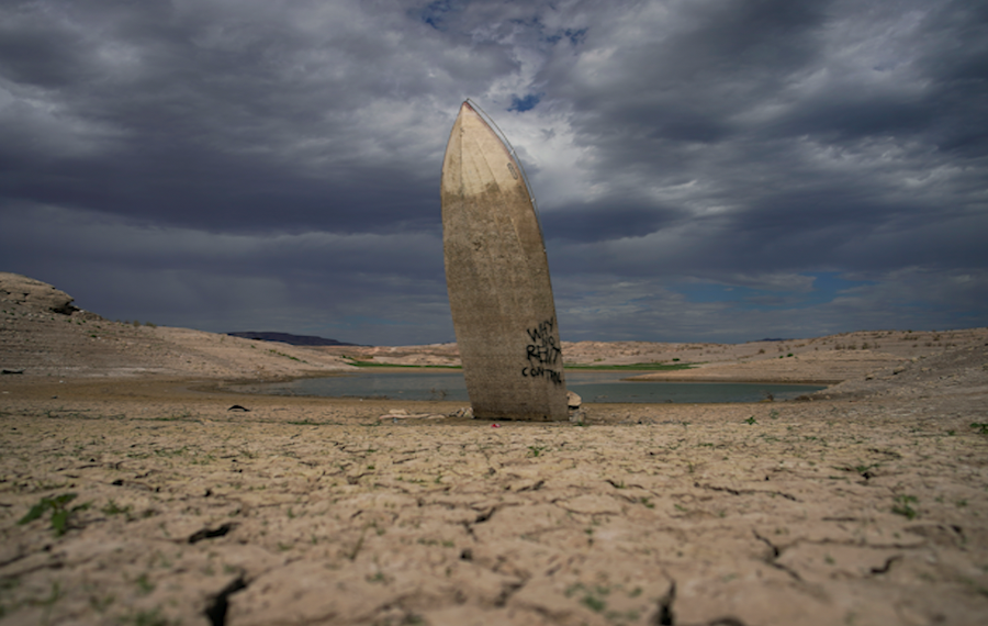 A formerly sunken boat sits upright into the air with its stern stuck in the mud along the shoreline of Lake Mead at the Lake Mead National Recreation Area, Wednesday, June 22, 2022, near Boulder City, Nev. Lake Mead water has dropped to levels it hasn't been since the lake initially filled over 80 years ago.
